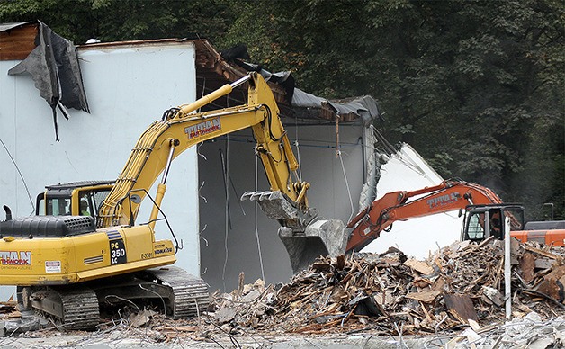 Two King County-owned warehouses are being torn down on Southeast 30th Street to make way for a new Factoria Transfer Station. Crews were razing the east building on Tuesday.