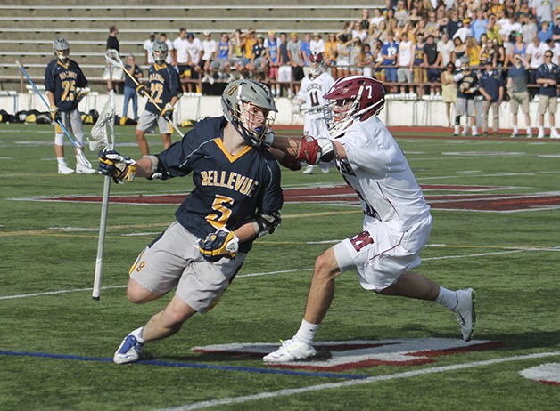 Bellevue's Augie Fratt (5) charges through Mercer Island defender Will Bassett on May 13. The Wolverines defeated the Islanders 14-3 to earn the No. 1 seed out of KingCo going into the postseason.