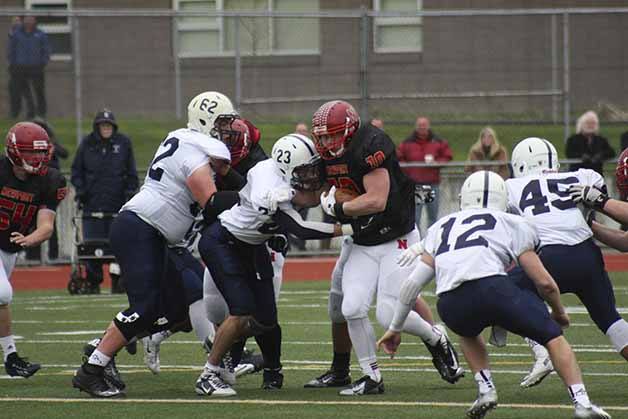 Newport running back Conner Baumann trucks Bellarmine Prep defenders on his way to one of three rushing touchdowns during his team's 38-35 loss.