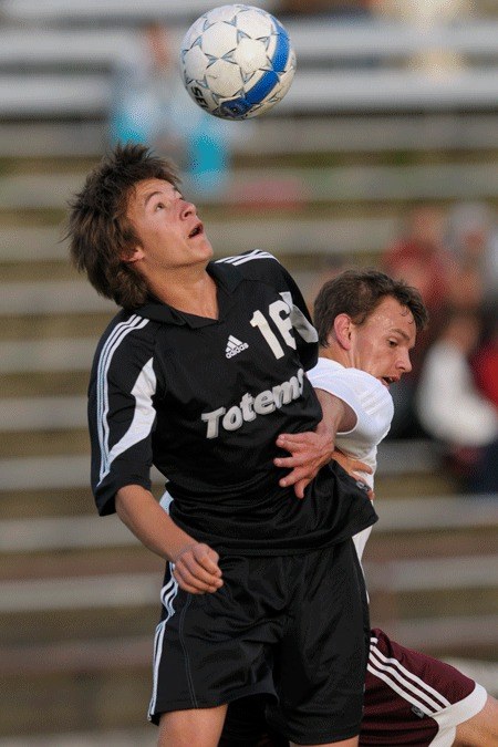 Sammamish defender Kittredge Hawkins (16) and Islanders David Yount battle for a ball during the KingCo title game at Mercer Island on Wednesday.