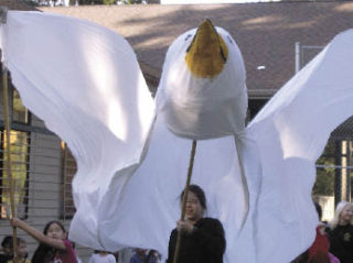 Eton students carry a dove that they made to promote World Awareness Day.
