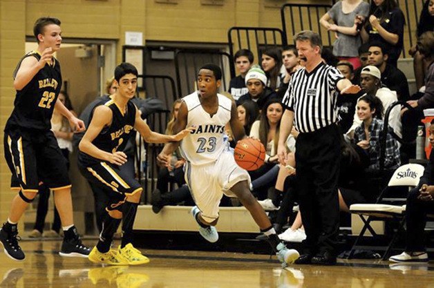 Interlake Saints guard Justin Jordan dribbles near the three-point line against the Bellevue Wolverines during a contest in the 2014-15 season. Jordan will be a senior during the 2015-16 season.
