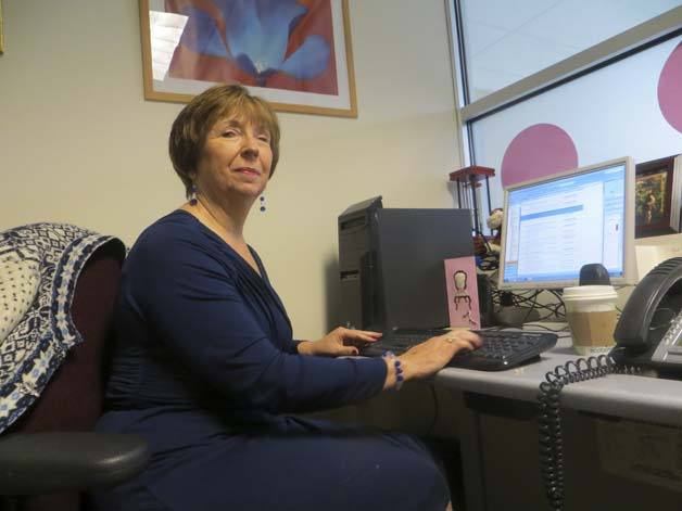 Susan Gjolmesli sits at her desk