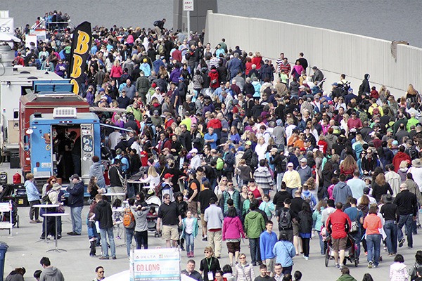 Thousands throng the State Route 520 bridge across Lake Washington.