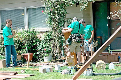 A crew from Lochwood-Lozier Custom Homes constructs a wheelchair ramp at the home of Roberta Bacha of Bellevue on Saturday