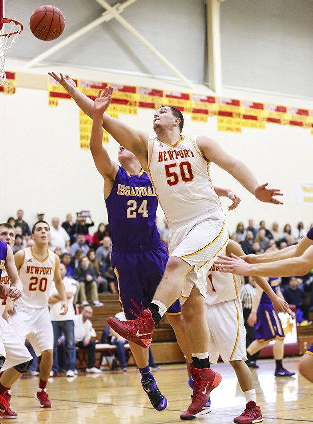 Newport senior Calvin Throckmorton gets past Issaquah defender Jack Dellinger for a basket in the low post on Jan. 3 at Newport High School in Factoria.