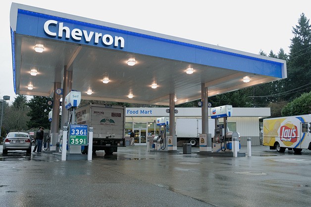 Customers go about their business at the Chevron station on Bellevue Way and 108th Avenue SE in Bellevue on Monday morning. Bellevue Police officers shot and killed a man with a knife in the early morning hours at the station.