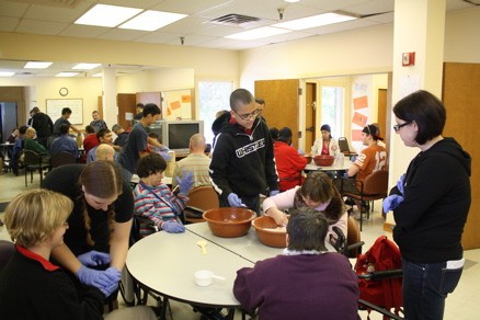 Participants from EADS and FEAT work together to make dog biscuits for Delta Society Pet Partners.