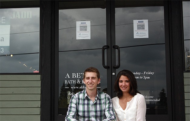 Chris McAboy and Allie Charneski sit outside the shuttered A Better Bath and Kitchen