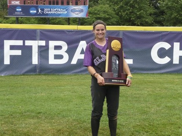 Alex Hartmann poses with the Division III softball National Championship trophy after her Linfield Wildcats defeated Christopher Newport of Virginia 6-2 to claim the crown.