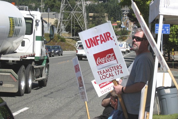 Workers from the Coca-Cola bottling and distribution center in Bellevue began picketing Monday over stalled contract negotiations.