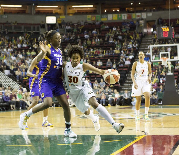 Tanisha Wright drives to the basket during a WNBA game.