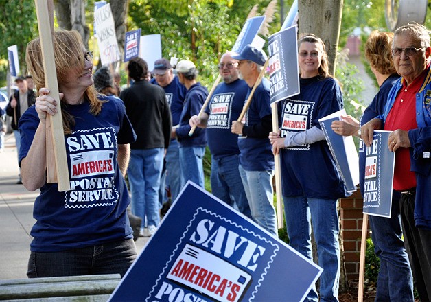 About 40 Postal Service employees rallied at Congressman Dave Reichert's office on Mercer Island to urge him to support legislation resolving post-office money problems.