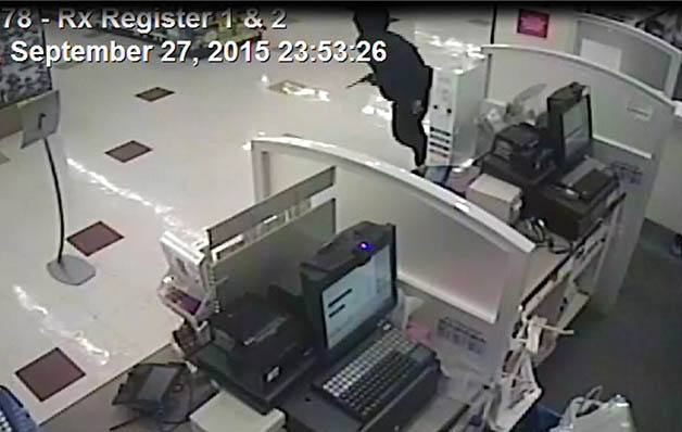Surveillance video footage showing one of the suspected robbers with what appears to be a gun.