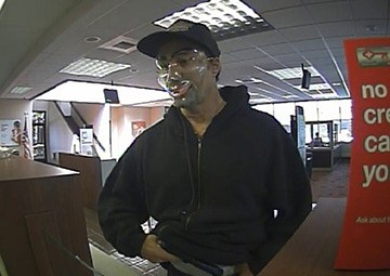 This image provided by the FBI shows a man robbing the Key Bank on Bellevue Way Northeast on Wednesday.