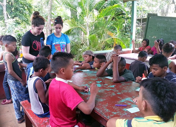 Aneesa (left) and Amara (right) Shaik teach paper quilling lessons at an orphanage in the town of San Marcos