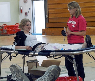 Emile Nelson checks on a donor during the Blood Drive she organized through the Puget Sound Blood Center. Forty-six people gave blood in the International School gym on Tuesday