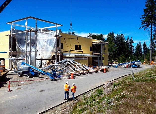 Workers with Absher Construction lift the tower cap of the future Snoqualmie Valley Hospital into place June 30. The new 70