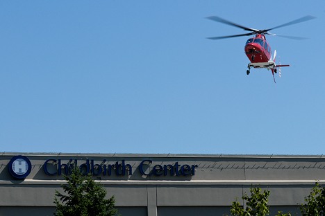An emergency medical helicopter makes a test landing at the new rooftop helipad at Overlake Medical Center near Northeast 12th Street and Interstate 405 in Bellevue on Thursday.
