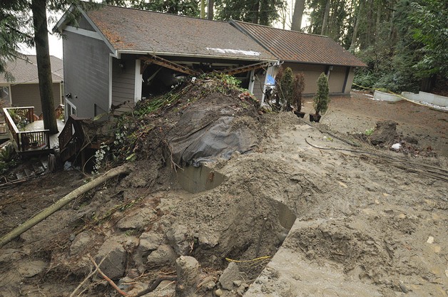 Crews continue to assess and cleanup a mudslide in the 500 block of West Lake Sammamish Parkway Southeast that forced the evacuation of four homes