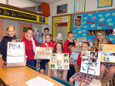 Students in Paula Patterson's sixth grade language arts program at St. Louise School decorate paper bags