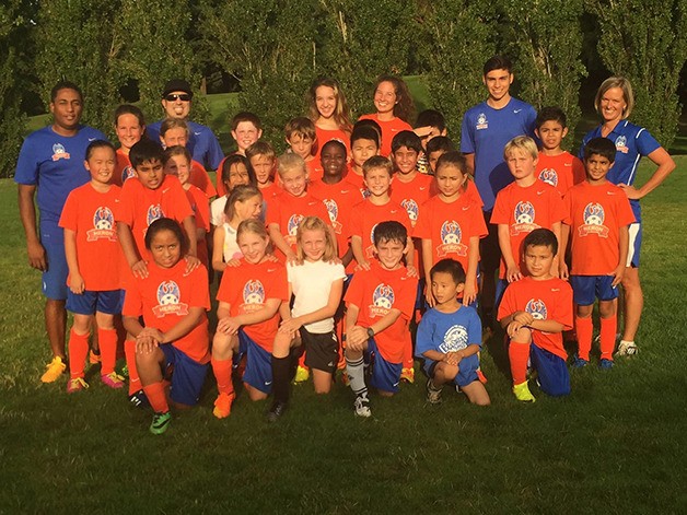 A group of Heron Athletic Club coaches and players from different age groups gather at a tournament earlier this summer. Heron offers soccer instruction to players between six and 17 years of age.