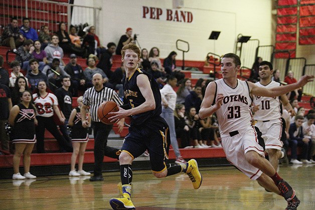 Bellevue Wolverines guard Kyle Foreman drives to the basket against the Sammamish Totems on Jan. 23 in Bellevue.