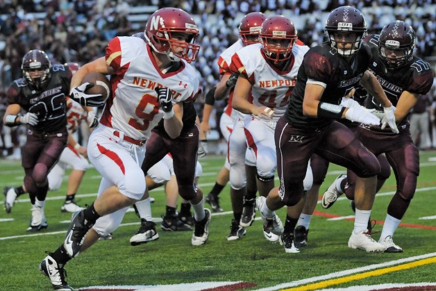 Knights RB James Dupar (9) runs past the Islander defense for a first quarter touchdown at Mercer Island on Friday. Newport outlasted the Islanders 28-21.