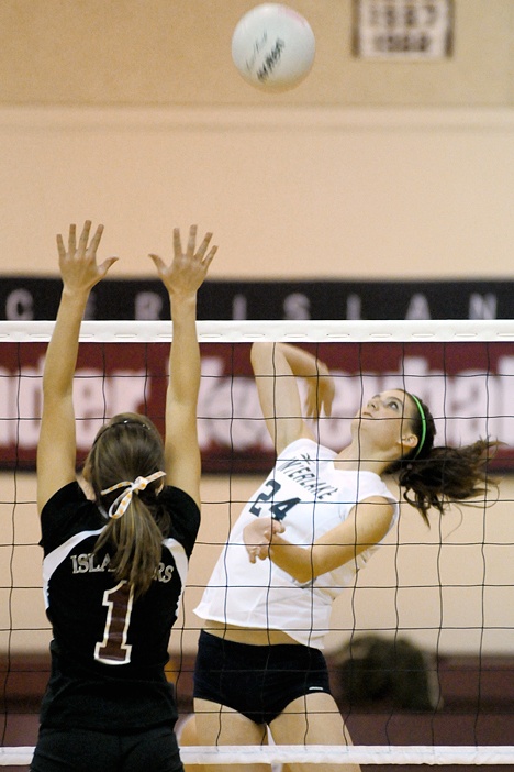 Saints Ashley Maitlen (24) attempts a kill shot at Mercer Island on Tuesday. The Islanders beat Interlake in 3 games -- 25-10