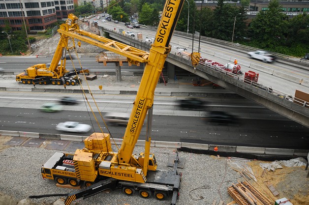 The two cranes pictured here will place girders for the new NE 12th Street bridge as part if the Interstate 405 braids project in Bellevue.