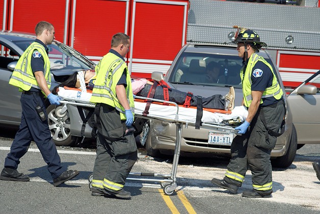 Bellevue firefighters help a person injured in a two-car crash Sunday