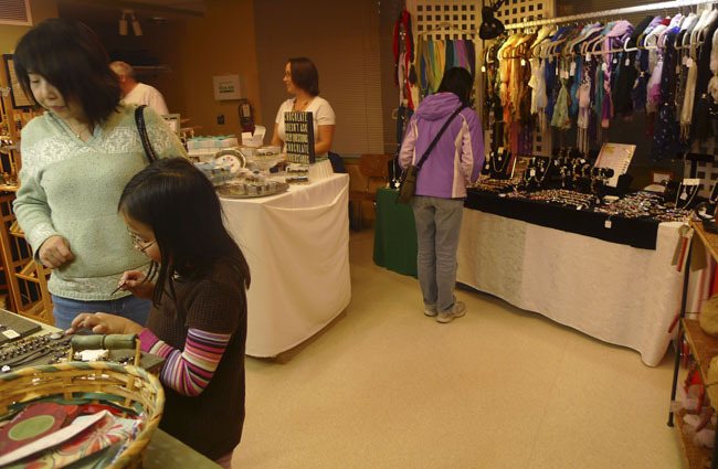 Vendor Sue Schleer offers samples of her homemade truffles at last week's Hilltop Holiday craft show. She was joined by 80 other vendors selling knit scarves