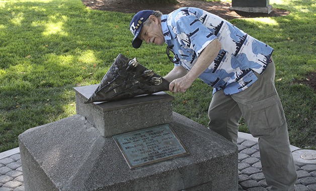 Veteran Robert Shay admires the new installment on the 'Lest We Forget' monument in Downtown Park. A crew placed the bronze flag