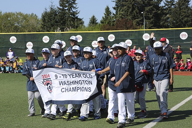 The 2014 Thunderbird 9/10 all-star team state champs close out the opening day parade with a stroll around the field on April 18.