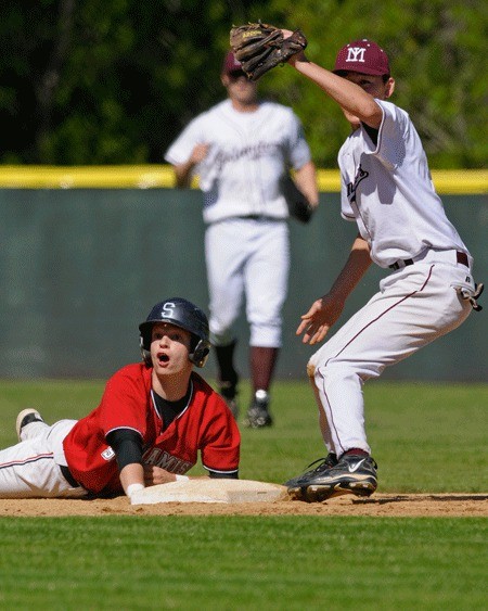 Totems Rick Teegarden (2) reacts as Islanders 2B Kirby Ingram shows the ball to the umpire after a steal attempt during Kingco 3A baseball playoffs at Bannerwood Park in Bellevue on Thursday