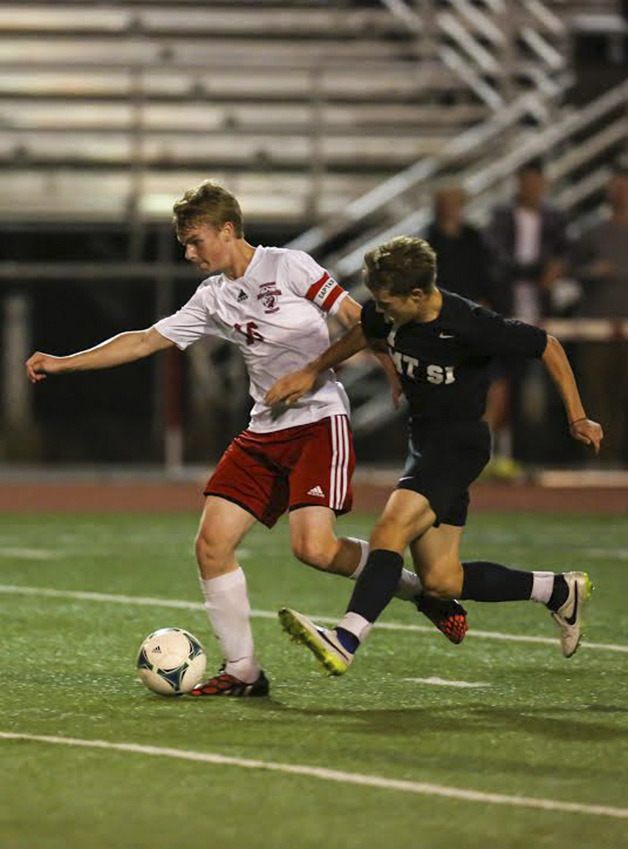 Newport defender Thomas Sikkema tries to break free of a Mount Si forward in the first half of play.