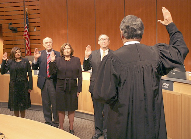 King County Superior Court Judge Brian Gain swears in (from left) Vandana Slatter