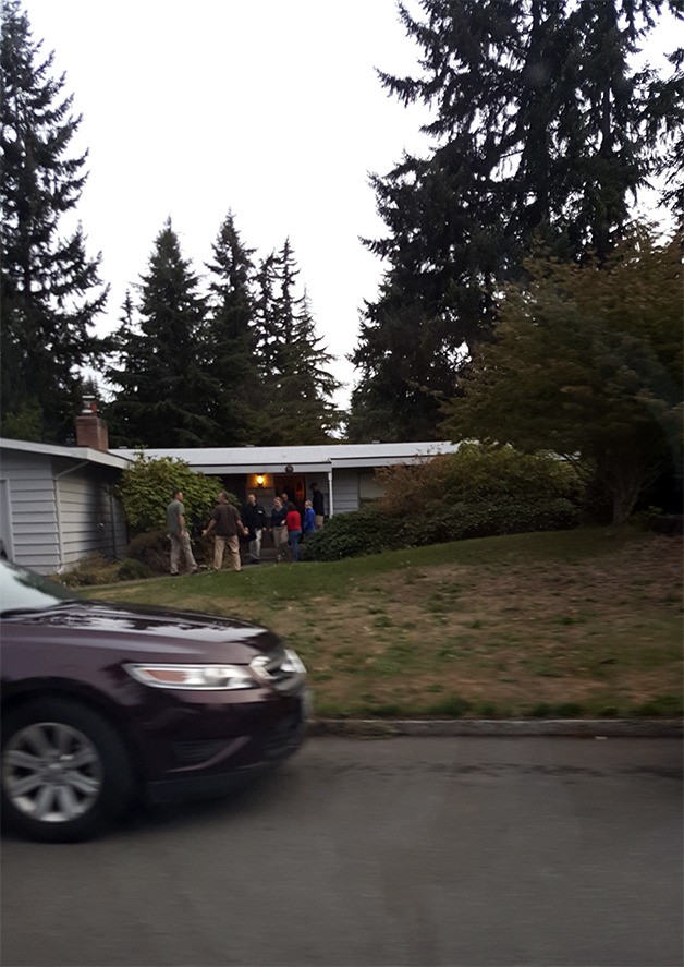 A photo showing FBI agents in the doorway of a home on the 15000 block of S.E. 25th Street around 6:30 a.m. on Sept. 14