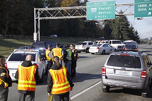 Investigators with the Washington State Patrol examine the scene after troopers ended a high speed chase using a PIT maneuver Monday morning. Traffic was backed up six miles for several hours while crews investigated.