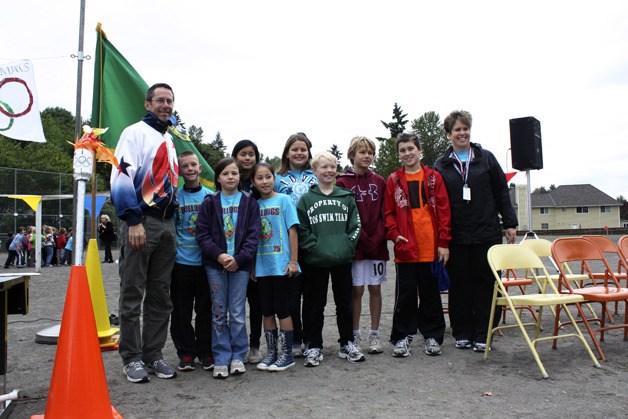 Fourth and fifth graders from Bennett Elementary pose with former Olympian Brad Barquist and Principal Nicole Hemworth as part of the Bennett Olympics opening ceremony.