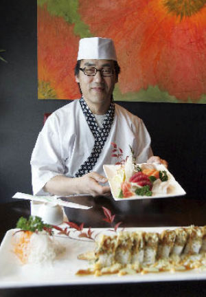 Chef Ung Jo of Zen Asian Bistro shows the sashimi platter and house sushi roll.