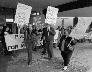 Carrying signs in support of public animal shelters are from the left: Vicki Hurley