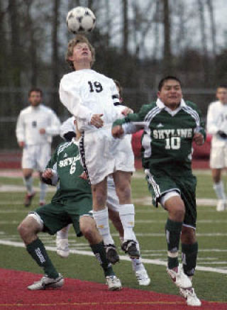 Newport’s Jacob Dance goes up to the ball as Skyline’s Edgar Esquivel