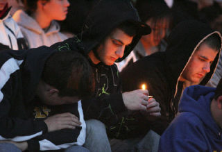 Friends of former Bellevue High School student Chase Anderson attend a candlelight vigil Friday in his memory at Bellevue High football field.  See story page 2