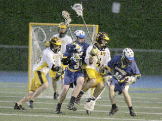 Bellevue lacrosse players Rusty Haehl (4) and Alex Candoo (28) go after the ball in a match against Bainbridge.