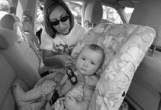 Carseat technician Janis McKelvey checks the babyseat where Chloe Manningsmith sits inside her mother Sarah’s (not in photo) vehicle during the Child Safety Fair & Baby Extravaganza at Factoria Mall on Saturday