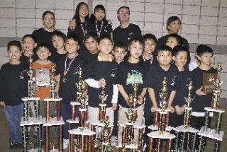 Stevenson Elementary students stand by the trophies they won.