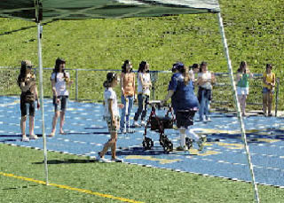 A participant in the assisted race completes the competition at Bellevue High School on Saturday