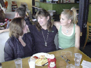 Brief Encounter Cafe regular Joanne Wright (left) chats with owner Melanie Bard (center) and Bard’s daughter