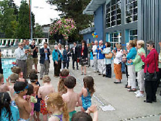 Young swimmers wait for the end of the grand opening dedication of new facilities at Samena Swim and Recreation Club on Friday